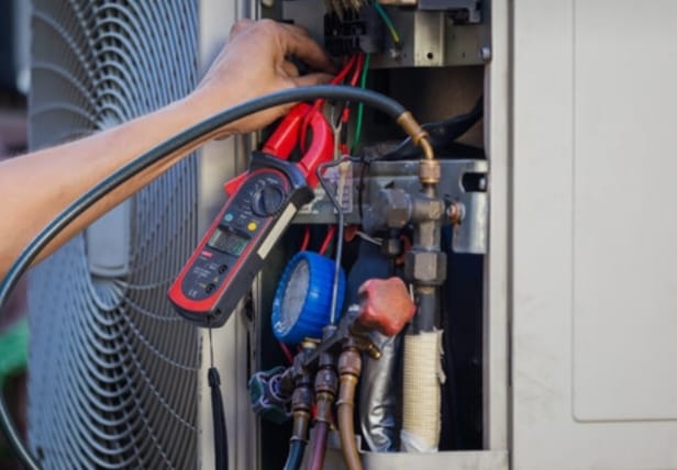 Refrigerator repair technician at work